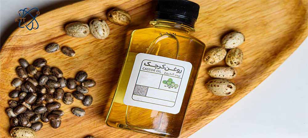 روغن و دانه های کوچک و قهوه ای کرچک در کنار هم