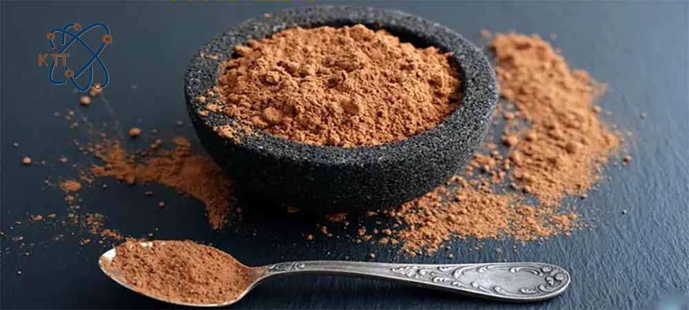 پودر قهوه ای تیره کلسیم لیگنوسولفونات داخل کاسه سنگی در کنار قاشق فلزی